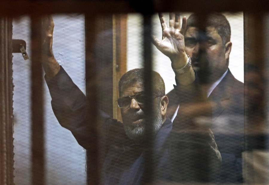 Deposed Egyptian President Mohammed Morsi behind bars after a court sentenced him to death in June 2015. Deposed Egyptian President Mohammed Morsi behind bars after a court sentenced him to death in June 2015.